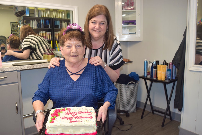 Tracey Harrietha, in back, a hairdresser at the Isle Royal Beauty Salon in Sydney, with former owner Joan MacKinnon. Harrietha said she will miss MacKinnon who retired Friday after 53 years in the business. Sharon Montgomery-Dupe/Cape Breton Post - Sharon Montgomery