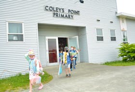 Students at Coley’s Point Primary leave for their buses for the last time on Wednesday.