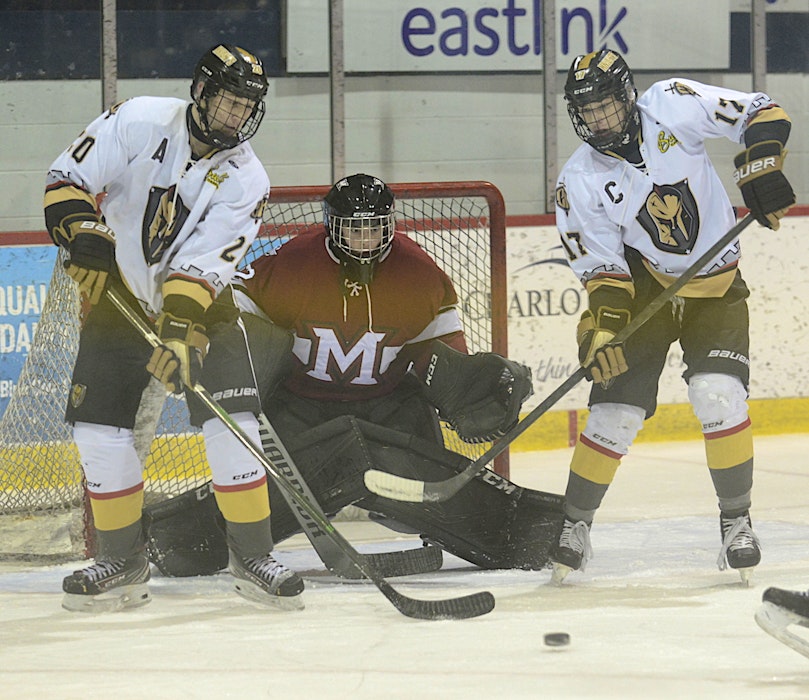 Mount Academy Saints goalie Jack Flanagan keeps an eye on a point shot while Charlottetown Bulk Carriers Knights forwards Cameron MacLean, left, and Max Chisholm look for a tip. - Jason Malloy