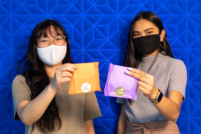Anka Chan (left) and Nicole Sanchez with Ruth show their company's sustainable Ruth Pads at their office in Edmonton, on Thursday, June 24, 2021. Ruth menstrual pads are made from natural materials including kenaf fibre, wood pulp, and a corn-based waterproof backing layer.