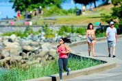 A jogger braves the heat near English Bay in Vancouver on Sunday amid record high temperatures.