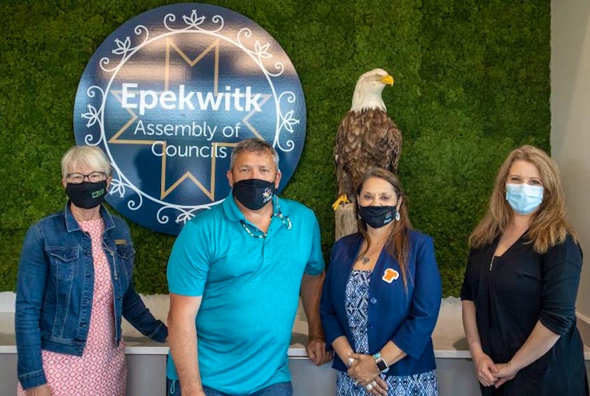 Island Nature Trust president June Jenkins Sanderson, left, and executive director Bianca McGregor, right, recently donated a taxidermy mounted eagle to the Epekwitk Assembly of Councils co-chairs, Chief Darlene Bernard, second right, and Chief Junior Gould.
