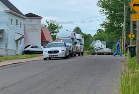 Police vehicles sit outside a West Pleasant Street residence on Monday afternoon. Amherst Police had part of the street closed off as it investigated what it’s calling a suspicious death.