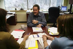 Dr. Roger Strasser speaks to two Northern Ontario School of Medicine students in his Sudbury office in 2005.
