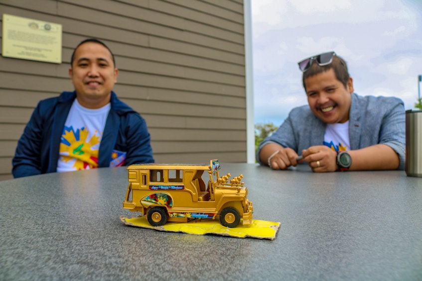 Jon Morales, left, and Julius Garcio look fondly on a model of a Jeepney, a popular mode of transportation in the Philippines. JESSICA SMITH/CAPE BRETON POST