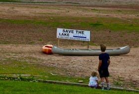 Children looked out at the dried lakebed as a Love the Lake rally got underway in Windsor June 27. People of all ages converged at the waterfront to show their appreciation of Lake Pisiquid in the hope that the federal government would lift the ministerial order mandating that the lake be drained.