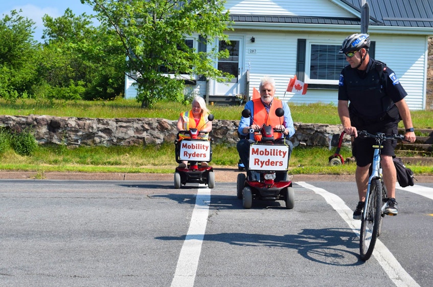 Councillors Alison Graham Fulmore and Bill Thomas are escorted across the road. - Chelsey Gould