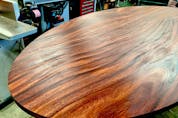 Finishing or refinishing a table top is one of the most demanding finishing tasks because the results are seen so closely. Steve finished this acacia wood table top using oil and a power buffing process. 
