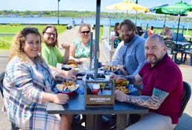 Perhaps it was the beautiful day or maybe the easing of COVID-19-related restrictions, but whatever the reason, Cape Breton residents starved for a sit-down meal have been flocking to outdoor patios and decks since they reopened on Wednesday. Above, this group of friends was found enjoying a bite of lunch on Thursday at the Portside pub on the Sydney waterfront. Clockwise from left: Courtney Richardson, Kyle Richardson, Nancy Beaton, Nick Jones and Wayne Jenkins. DAVID JALA/CAPE BRETON POST