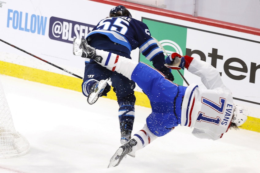 Winnipeg Jets centre Mark Scheifele (55) hits Montreal Canadiens centre Jake Evans (71) in the third period of Game 1 of the second round of the 2021 Stanley Cup Playoffs at Bell MTS Place in Winnipeg on Wednesday. - James Carey Lauder / USA Today Sports