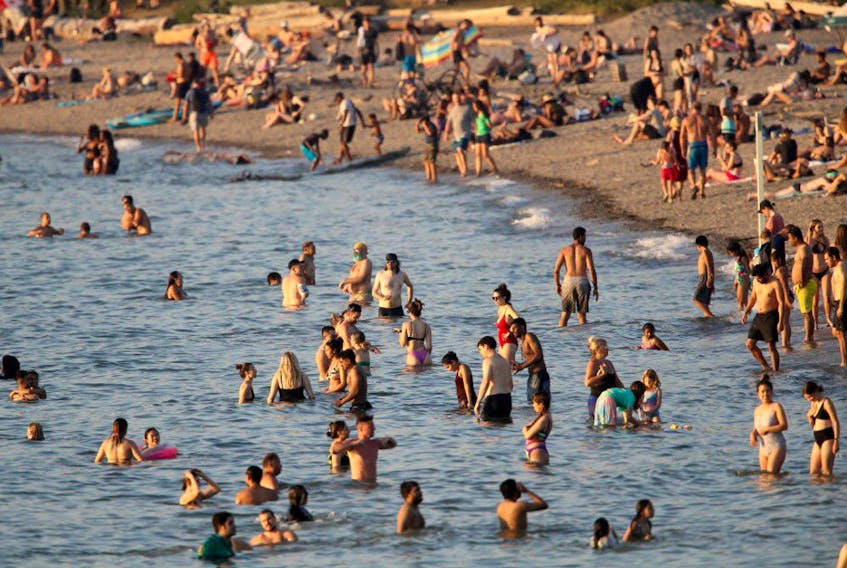 Beachgoers on Kitsilano Beach during a heatwave in Vancouver, British Columbia, Canada, on Monday, June 28, 2021. Canadians could start regaining a sense of normality by the end of this year, Raywat Deonandan said. 