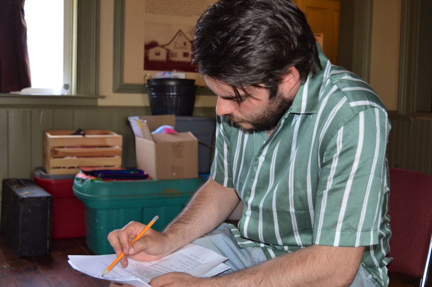 Luc Trottier looks over the script for the St. Peters Bay Community Players, a television series that was being filmed at the St. Peters Bay Courthouse Theatre in June. It will be broadcast in September on Bell TV. - Dave Stewart • The Guardian