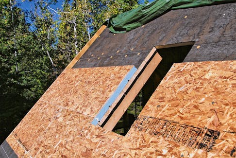 This roof is being insulated from the top using rigid sheets of extruded polystyrene foam. It allows the roof boards and rafters to remain visible from inside when maximum insulation levels are not needed.