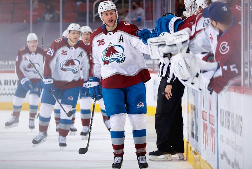Mikko Rantanen of the Colorado Avalanche celebrates with teammates on the bench after scoring a goal against the Arizona Coyotes during the first period of the NHL game at Gila River Arena on March 22, 2021 in Glendale, Arizona.