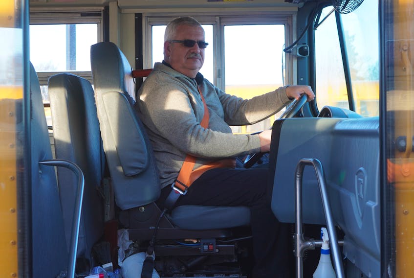Mike Franklin, transportation logistics specialist with the Public Schools Branch, sits in the driver's seat of a diesel bus in Charlottetown in February. 