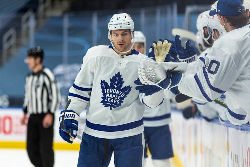 Maple Leafs’ Zach Hyman celebrates with teammates after scoring a goal on Oilers’ goaltender Mikko Koskinen in Edmonton on March 1, 2021.