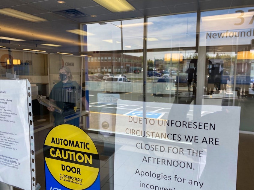 An RNC officer stands inside the Bank of Montreal branch on Newfoundland Drive in St. John's after an alledged armed robbery on Monday, June 7. - Keith Gosse