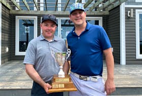 Kris Currie, left, receives the Countryview Open trophy Saturday from the defending champion Adam Constable, who won the event in 2019.