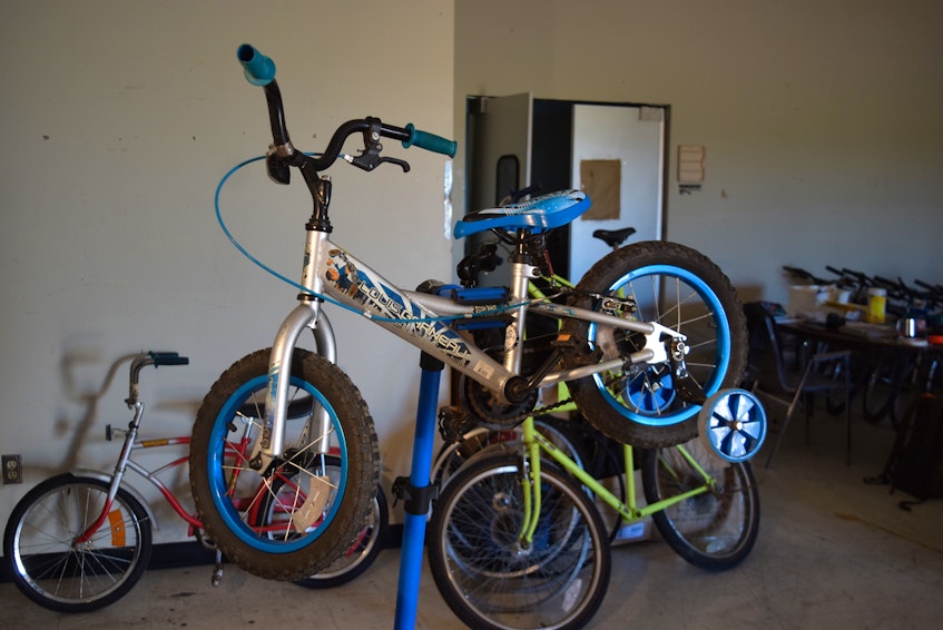 Volunteers can learn how to repair bikes, such as this one, from the team of mechanics.  - Chelsey Gould