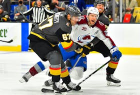 Vegas Golden Knights players Shea Theodore (27) and Max Pacioretty (67) converge on Colorado Avalanche centre Nathan MacKinnon (29) during the third period of Game 3 of the second round of the 2021 Stanley Cup Playoffs at T-Mobile Arena in Las Vegas.