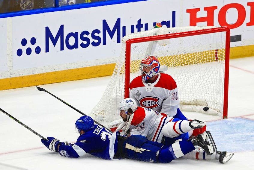 Lightning's Blake Coleman dives past Phil Danault and beats goalie Carey Price for a goal with 0.3 seconds left in the second period Wednesday night in Tampa.