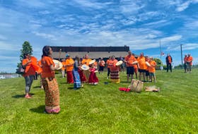 Acadia First Nation Walk of Remembrance in Yarmouth on Canada Day, 2021. Performing the Honour Song on the lawn of the Yarmouth rural RCMP detachment. TINA COMEAU PHOTO