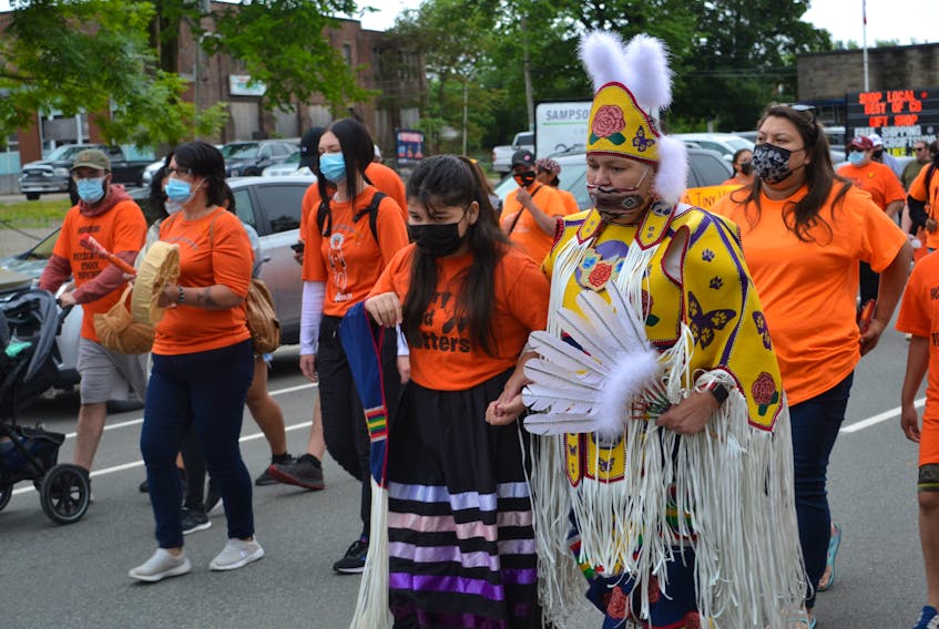 Margaret Tuplin walked with her 11-year-old granddaughter, Evaeh Joe, and close to 2,000 others from Sacred Heart Church in the northend of Sydney to the Wentworth Park bandshell. Tuplin said she was walking for her grandmother, a residential school survivor. ARDELLE REYNOLDS/CAPE BRETON POST