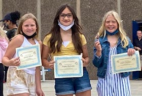 Students at Dr. T. L. Sullivan School in Florence, Jocelyn Billard, Poppy MacLean and Claire Phillips, show off their grading certification, happy to be heading into Grade 7 next year. CONTRIBUTED 