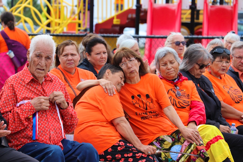 Elders and residential school survivors were seated at the front of the ceremony. Survivor Margaret Labobe-Provencher can be seen comforting fellow Survivor, Marlene Thomas. - Logan MacLean