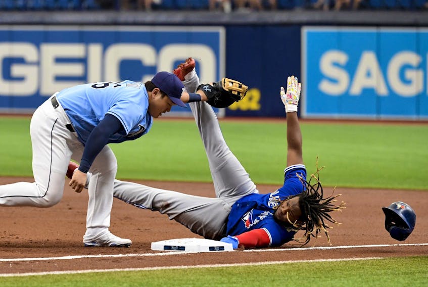 Vladimir Guerrero Jr. of the Toronto Blue Jays is thrown out at first base by Mike Zunino #10 (not pictured) as Ji-Man Choi #26 of the Tampa Bay Rays makes the tag during the first inning at Tropicana Field on Saturday. 
