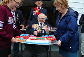 Second World War Navy veteran Bill Saunders cuts his birthday cake marking his 100th Birthday Saturday.