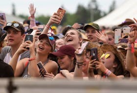 Festival-goers take out their phones to capture some of the performances at the last Cavendish Beach Music Festival in 2019. 