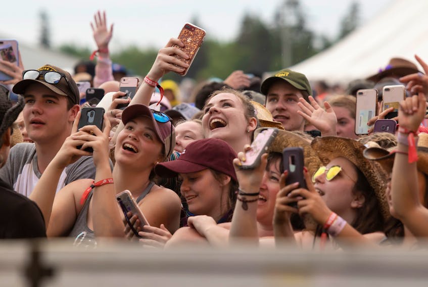 Festival-goers take out their phones to capture some of the performances at the last Cavendish Beach Music Festival in 2019. 