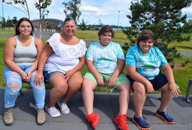 Tania Bond-MacNeil of Bras d'Or, second from left, with her children, from left, Emmaleigh MacNeil, 14, and William MacNeil, 13, and his twin brother Alexander. The family was nearly scammed as they attempted to purchase a dog off Facebook. Sharon Montgomery-Dupe • Cape Breton Post