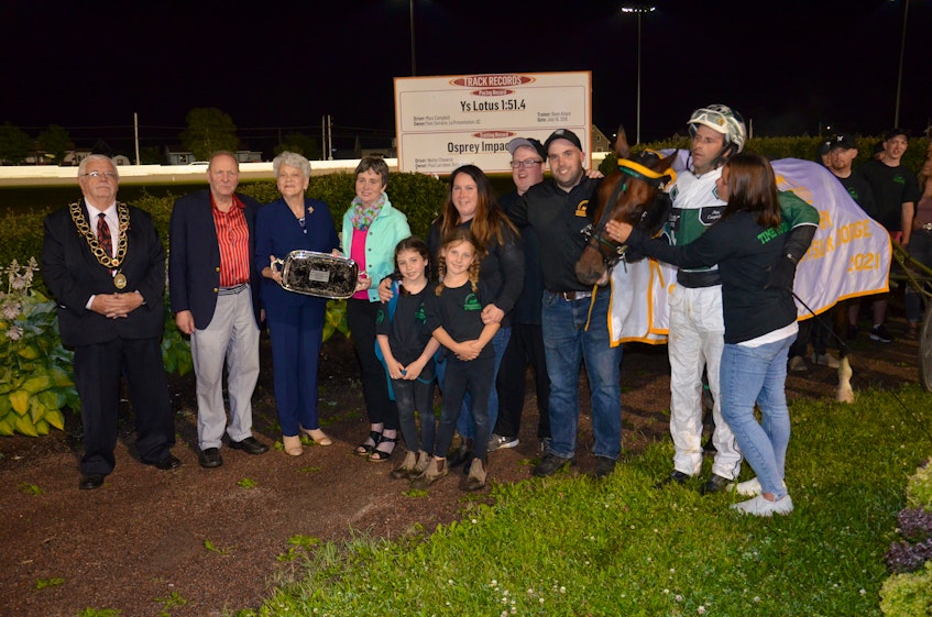Time To Dance won the 53rd edition of the $25,000 Governor's Plate, presented by Summerside Chrysler Dodge, in 1:53.1 at Red Shores at Summerside Raceway on July 10. P.E.I. Lt.-Gov. Antoinette Perry, third left, presents the 2021 Governor's Plate to Jacinta Campbell, wife of the late Richard Campbell. Richard, who died July 6, shared ownership in Time To Dance with his son, Brent Campbell, and Matthew Mcdonald. Also taking part in the presentation are, from left: Summerside Mayor Basil Stewart; Warren Ellis of Summerside Chrysler Dodge; Brent's wife, Ambyr Campbell, and their two daughters, Mylah (left) and Brielle; Bo Ford, assistant trainer; Brent Campbell, who also served as the groom and trainer and driver Marc Campbell and his wife, Natasha. - Jason Simmonds