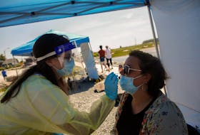 FOR NEWS STANDALONE:
An emergency support aide, conducts a swab test for COVID-19, at a Public Health Mobile Testing site,  near the boardwalk at McCormacks Beach Provincial Park near Fishermen's Cove in Eastern Passage Tuesday July 13, 2021. - Tim Krochak