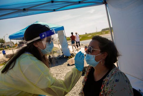 FOR NEWS STANDALONE:
An emergency support aide, conducts a swab test for COVID-19, at a Public Health Mobile Testing site,  near the boardwalk at McCormacks Beach Provincial Park near Fishermen's Cove in Eastern Passage Tuesday July 13, 2021. - Tim Krochak