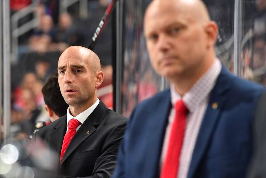  Mitch Love, hired by the Calgary Flames to be head coach of the Stockton Heat, has worked with Hockey Canada’s Program of Excellence, including this bench assignment alongside Andre Tourigny, right, at the 2018 Hlinka Gretzky Cup.