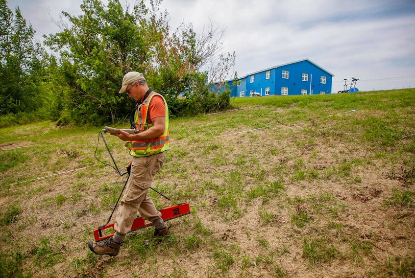 FOR DEMONT STORY:
Archaeologist Jonathan Fowler, uses an electro-magnetometer near the site of the former Shubenacadie residential school near Shubenacadie, NS Monday July 12, 2021. Fowler is taking part in the burial investigation.

TIM KROCHAK PHOTO 