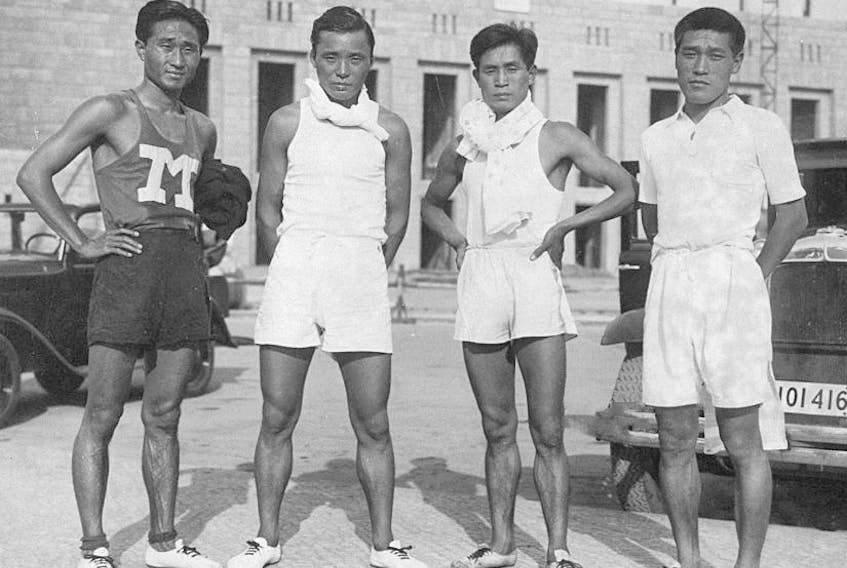 Shoryu Nan or Nam Sung-yong, Tamao Shiwaku, Fusashige Suzuki and Kitei Son or Son Gi-jeong pose for photographs after a training ahead of the Berlin Olympic on June 19, 1936 in Berlin, Germany.
