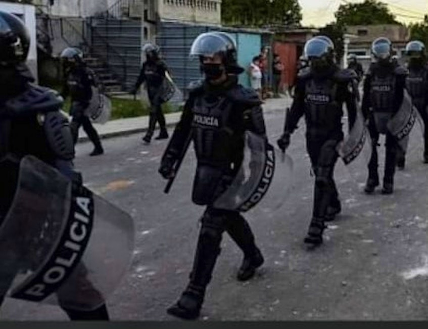 Men in riot gear advance in Cuba. - Contributed