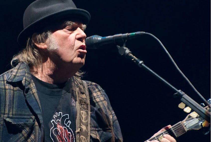  Neil Young, pictured performing in 2018, is one of the more than 100 authors, academics and celebrities who have signed a letter urging Prime Minister Justin Trudeau to scrap his plan to spend billions on new fighter jets. Alice Chiche /AFP