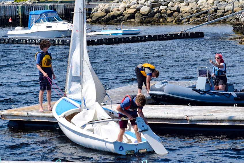 Instructors and a student tie up at the Shelburne Harbour Yacht Club Sailing Academy floating docks after a day on the water. KATHY JOHNSON 