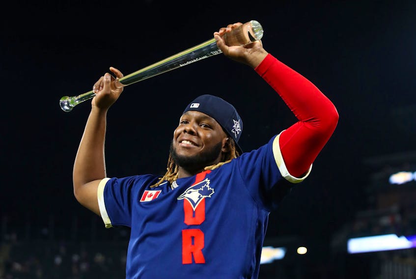 American League first baseman Vladimir Guerrero Jr. of the Blue Jays hold up his trophy after being named MVP of the 2021 MLB all star game at Coors Field on July 14 in Denver. 