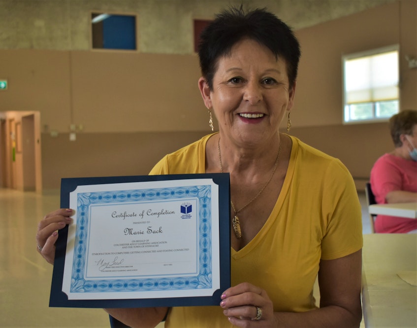 Marie Sack proudly holds up the certificate which indicates she completed the course, which took place from June 14 to July 7. - Richard MacKenzie
