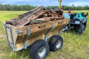  A Hubley trailer in action on Steve Maxwell’s farm. Lots of room, dumping capabilities and walking beam suspension make this trailer work exceptionally well.