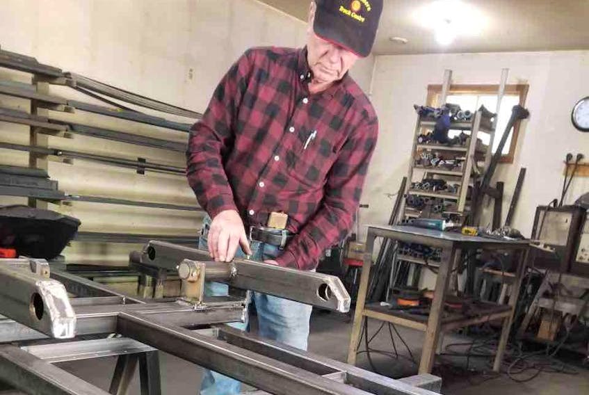  Allan building a walking beam for one of his trailers.