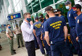 Premier Iain Rankin chats with a group of provincial firefighters as they prepare for deployments in Manitoba and Ontario to fight wildfires at Halifax Stanfield International Airport Friday July 16, 2021.
