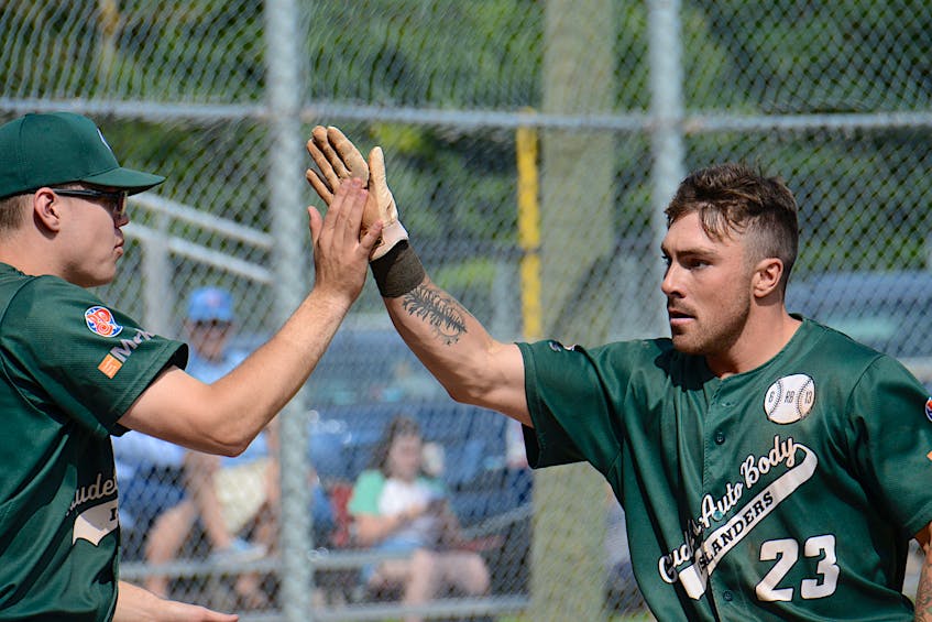 Grant Grady, left, high-fives Avery Arsenault in the bottom of the first inning after Arsenault scored the go-ahead run against the Saint John Alpines on July 17 at Memorial Field. - Jason Malloy