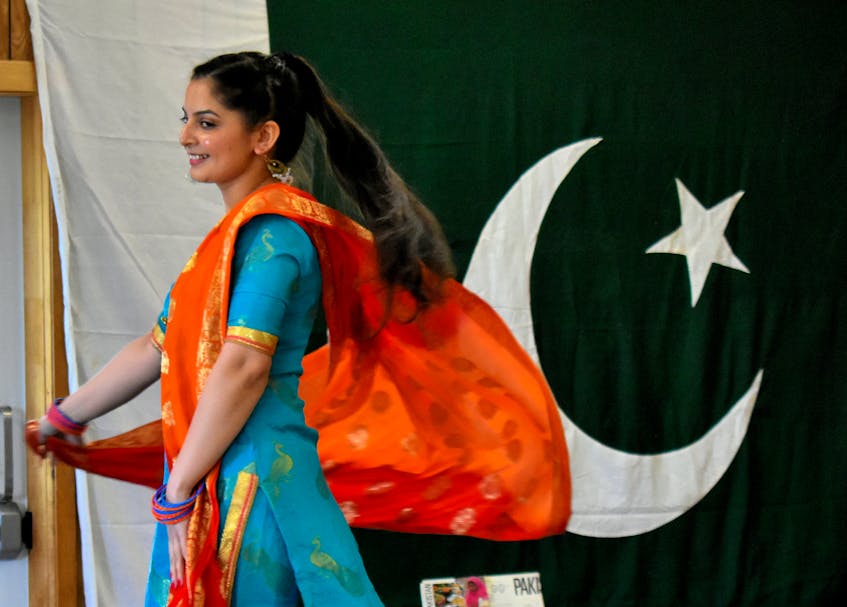 Harman Beniwal twists and twirls as she models the national dress of Pakistan for women, called shalwar kameez and worn with a scarf. The outfits can come in different colours and styles. - Desiree Anstey